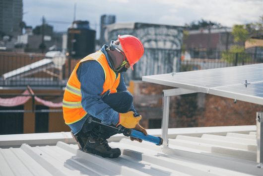 men on rooftop with electrical tool